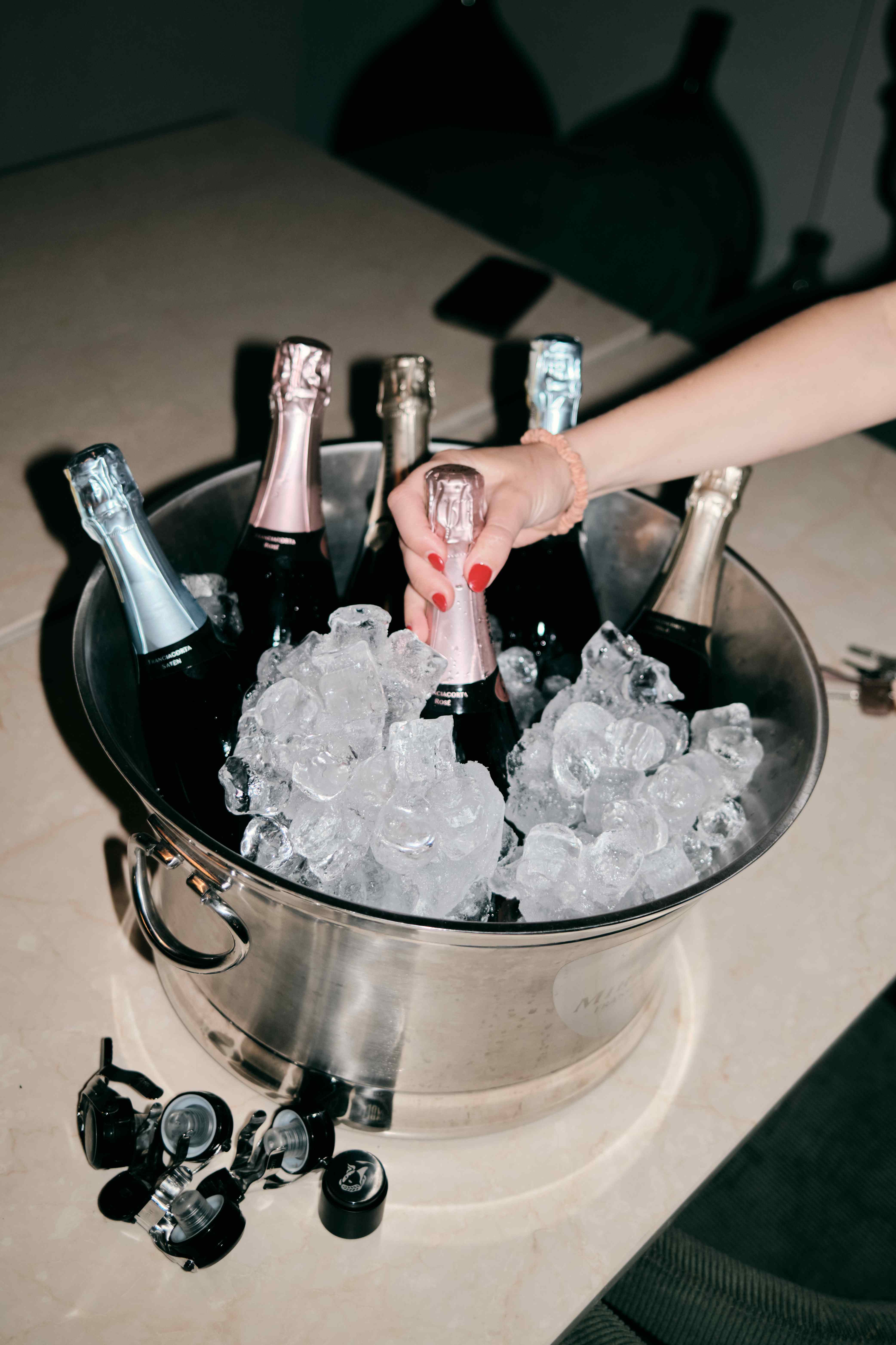 Franciacorta sparkling wine bottles on ice during a private tasting