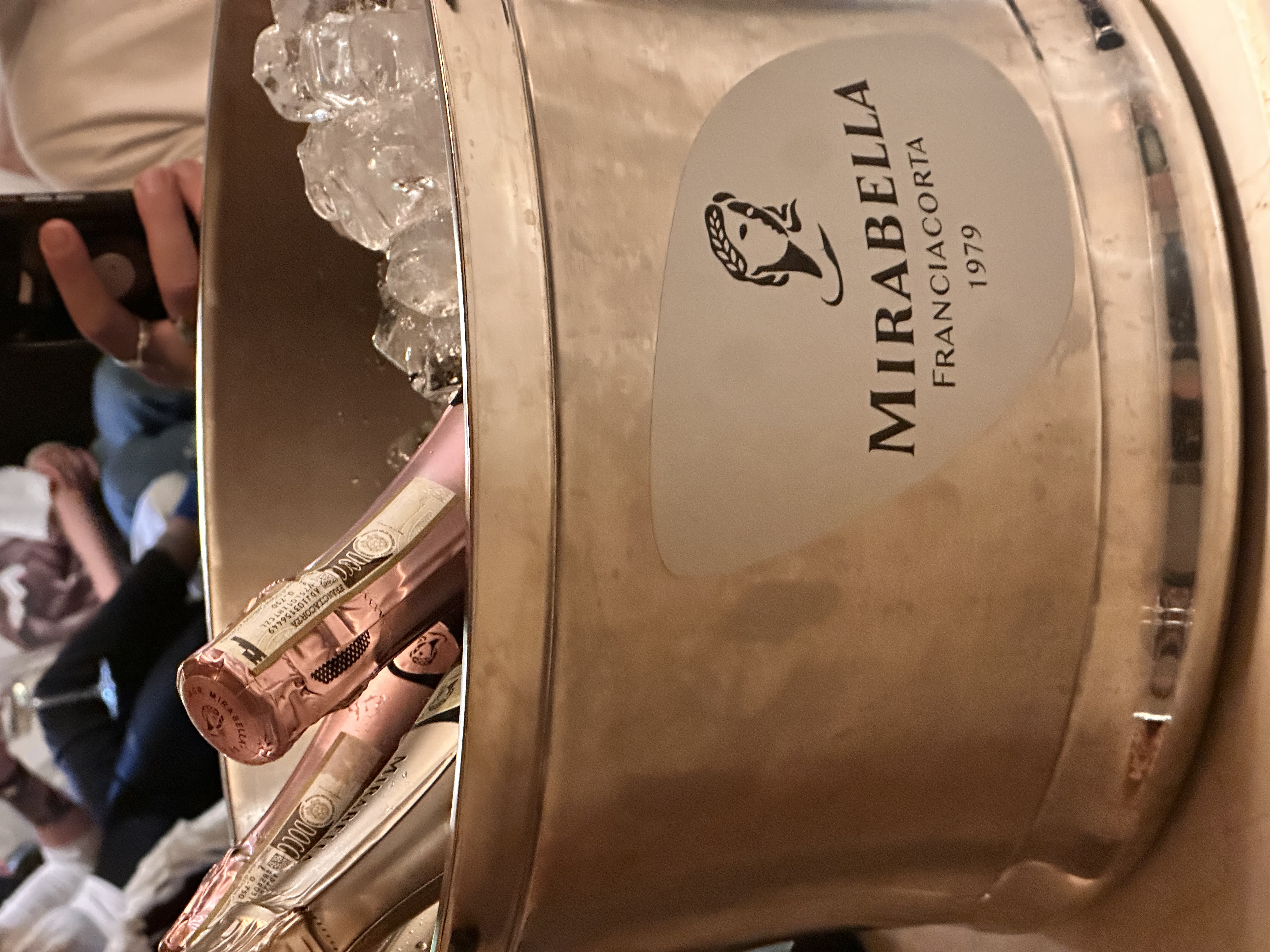 Mirabella Franciacorta rosé bottles chilling in a copper ice bucket