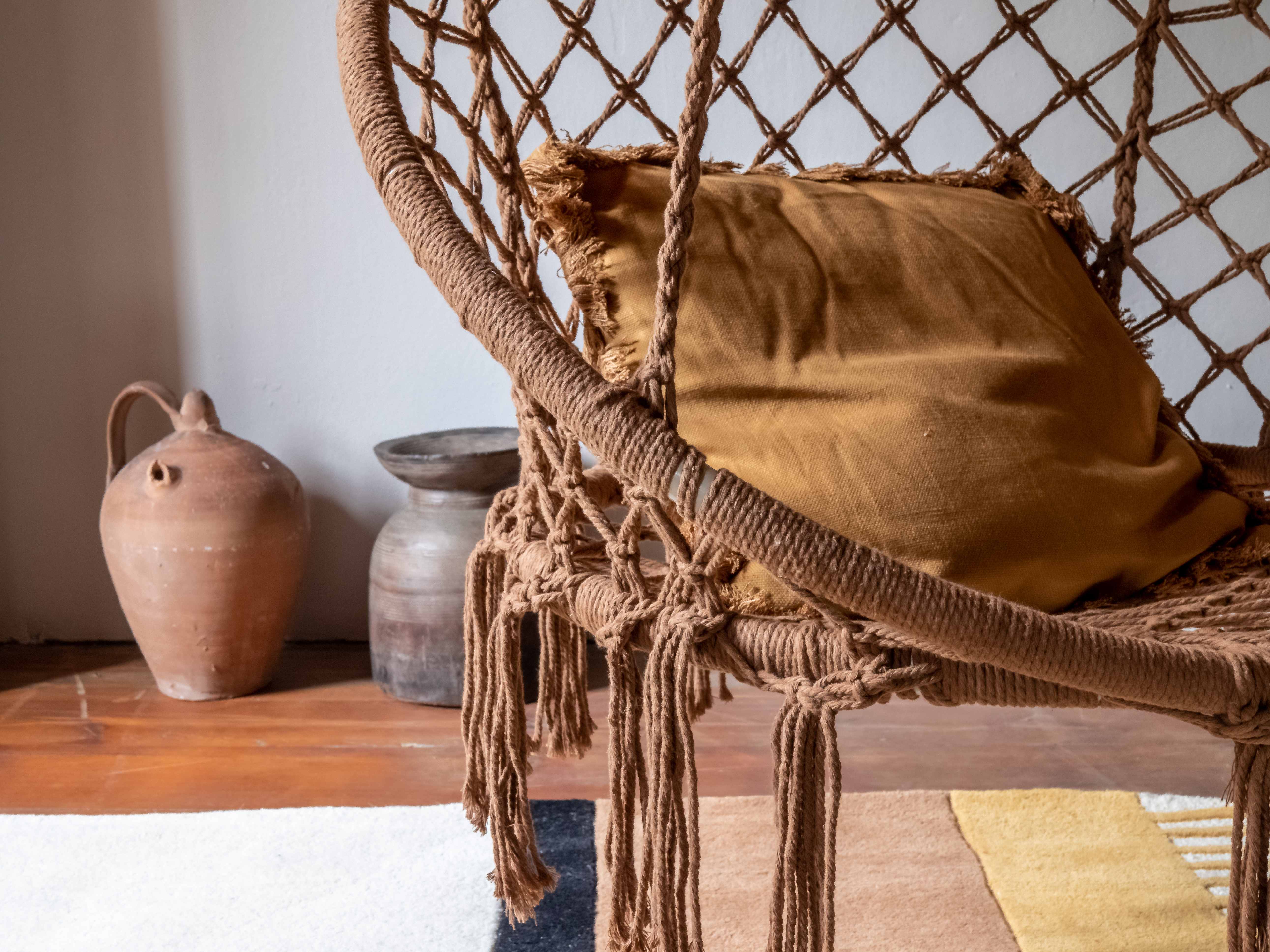 Detailed view of macrame hammock chair with ceramic pottery