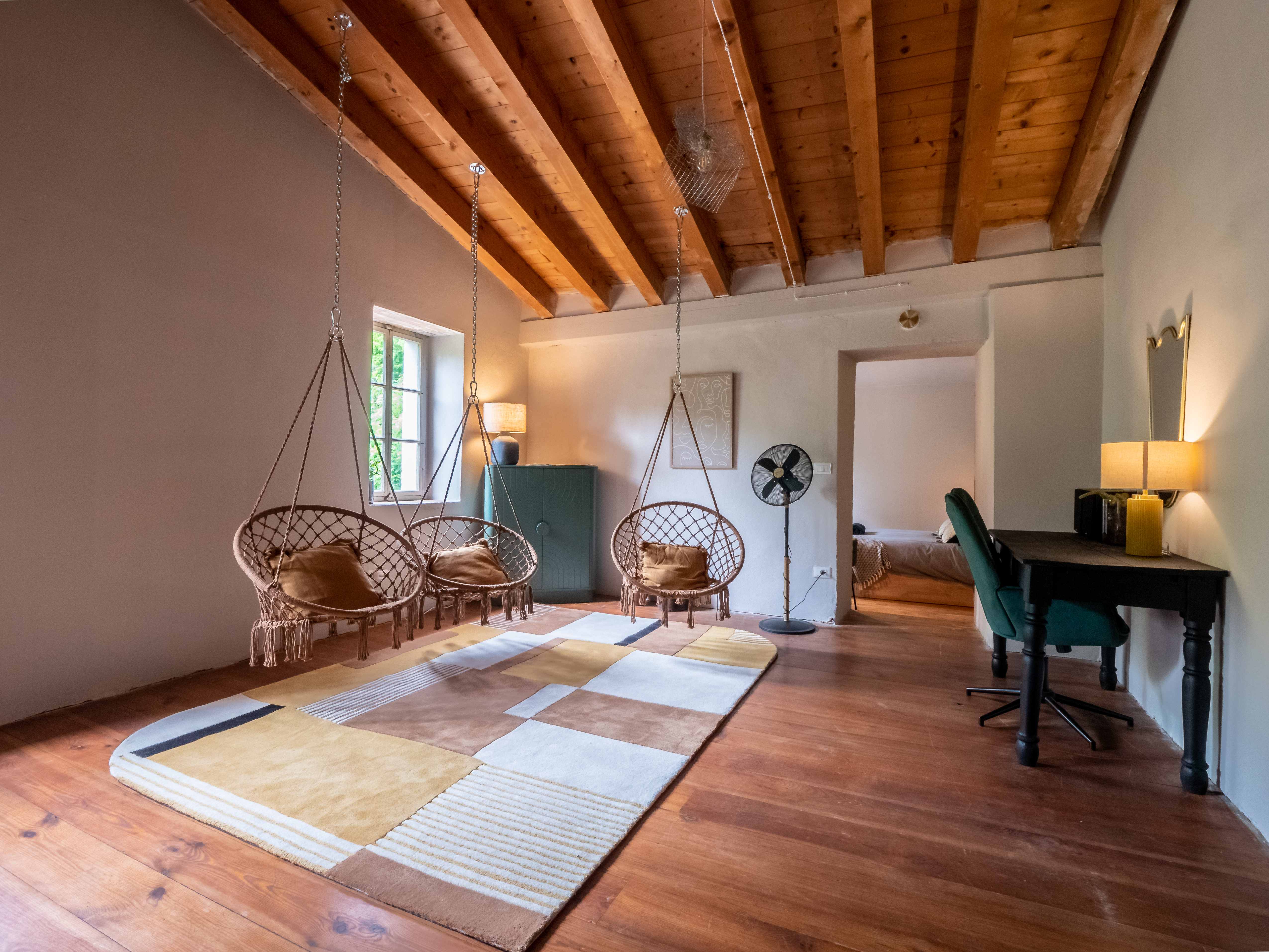 Multiple macrame hammock chairs in loft space