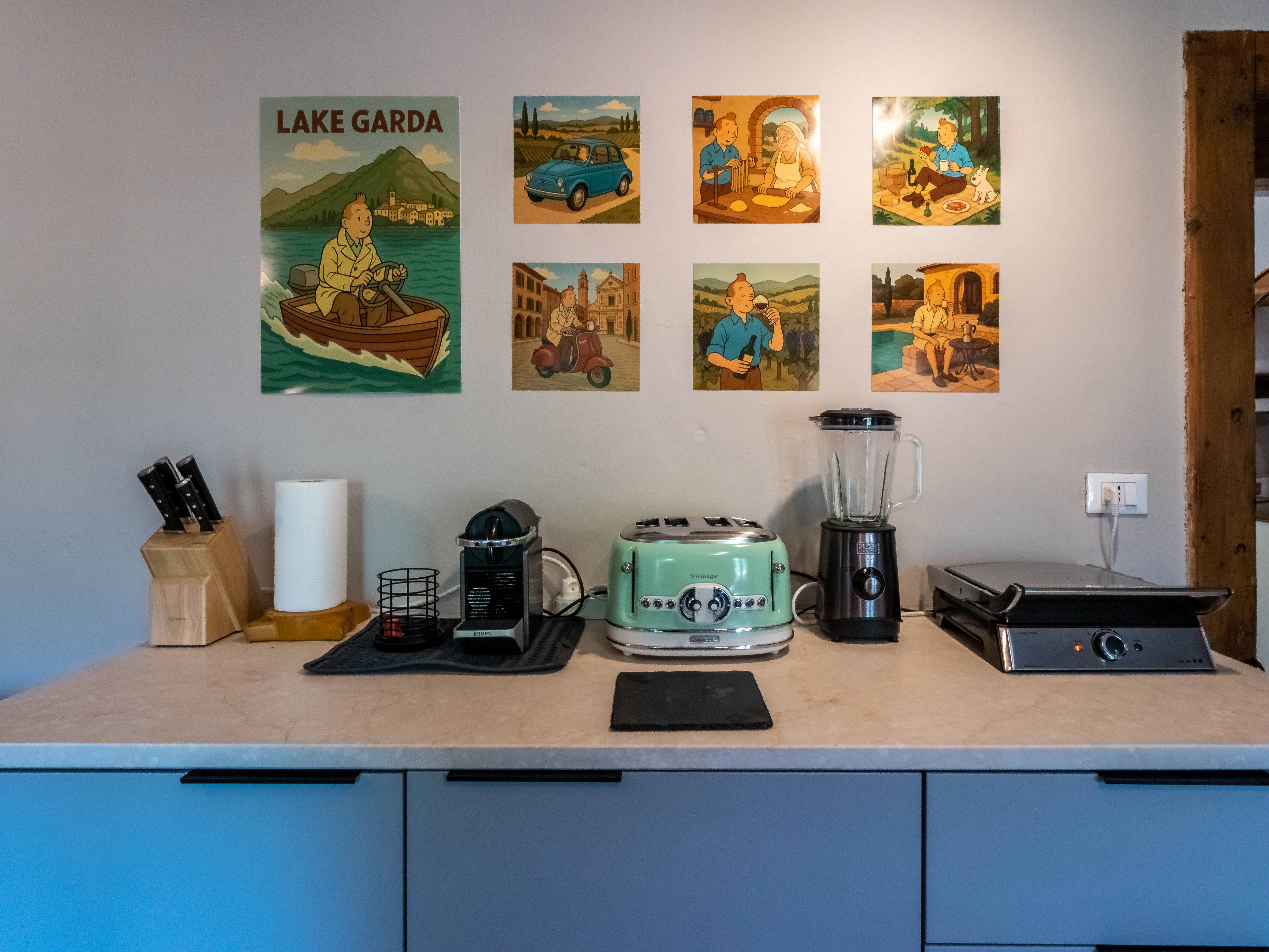 Kitchen counter with vintage appliances and Italian artwork