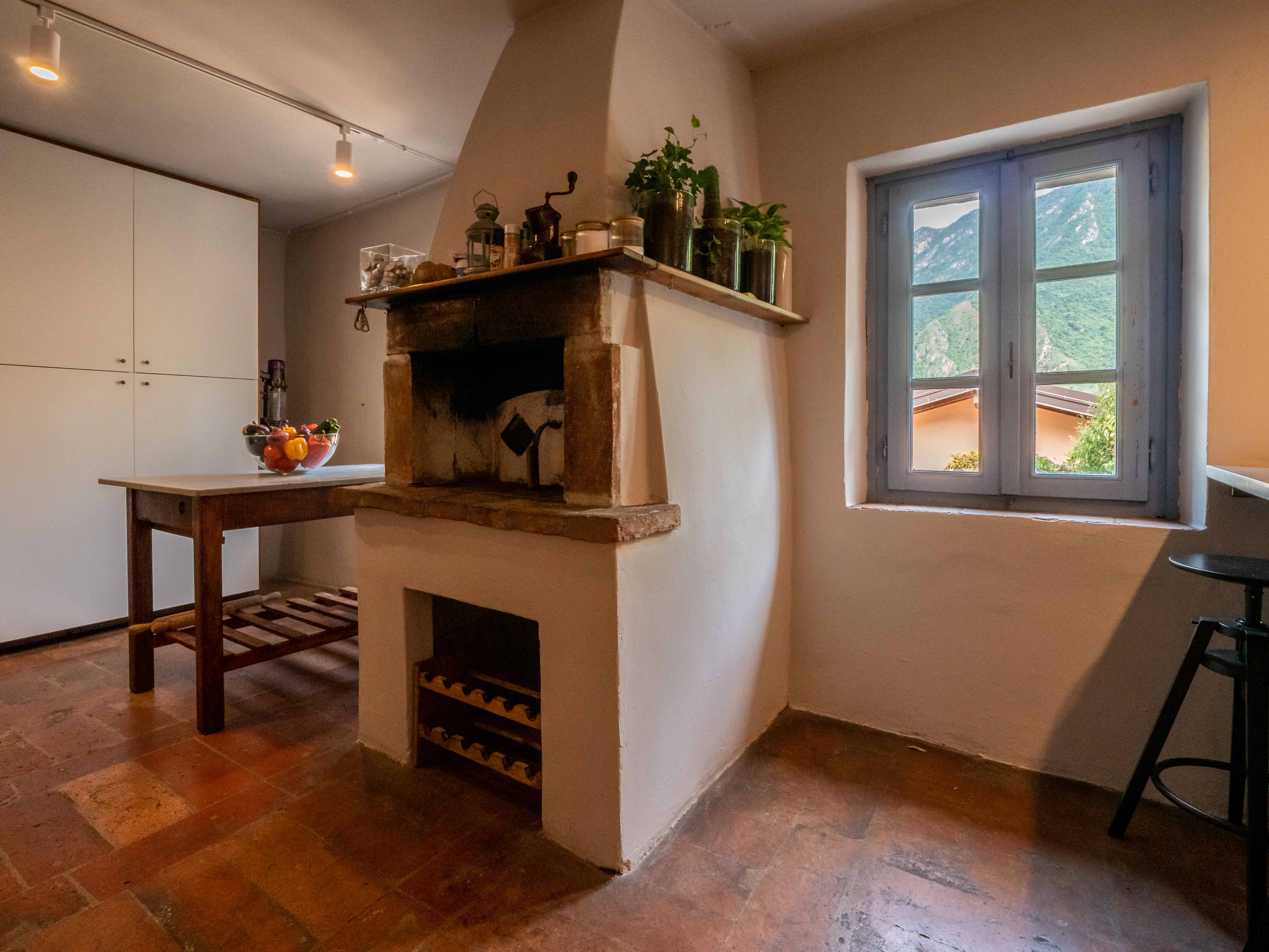 Ancient stone fireplace with mountain views and wooden work table
