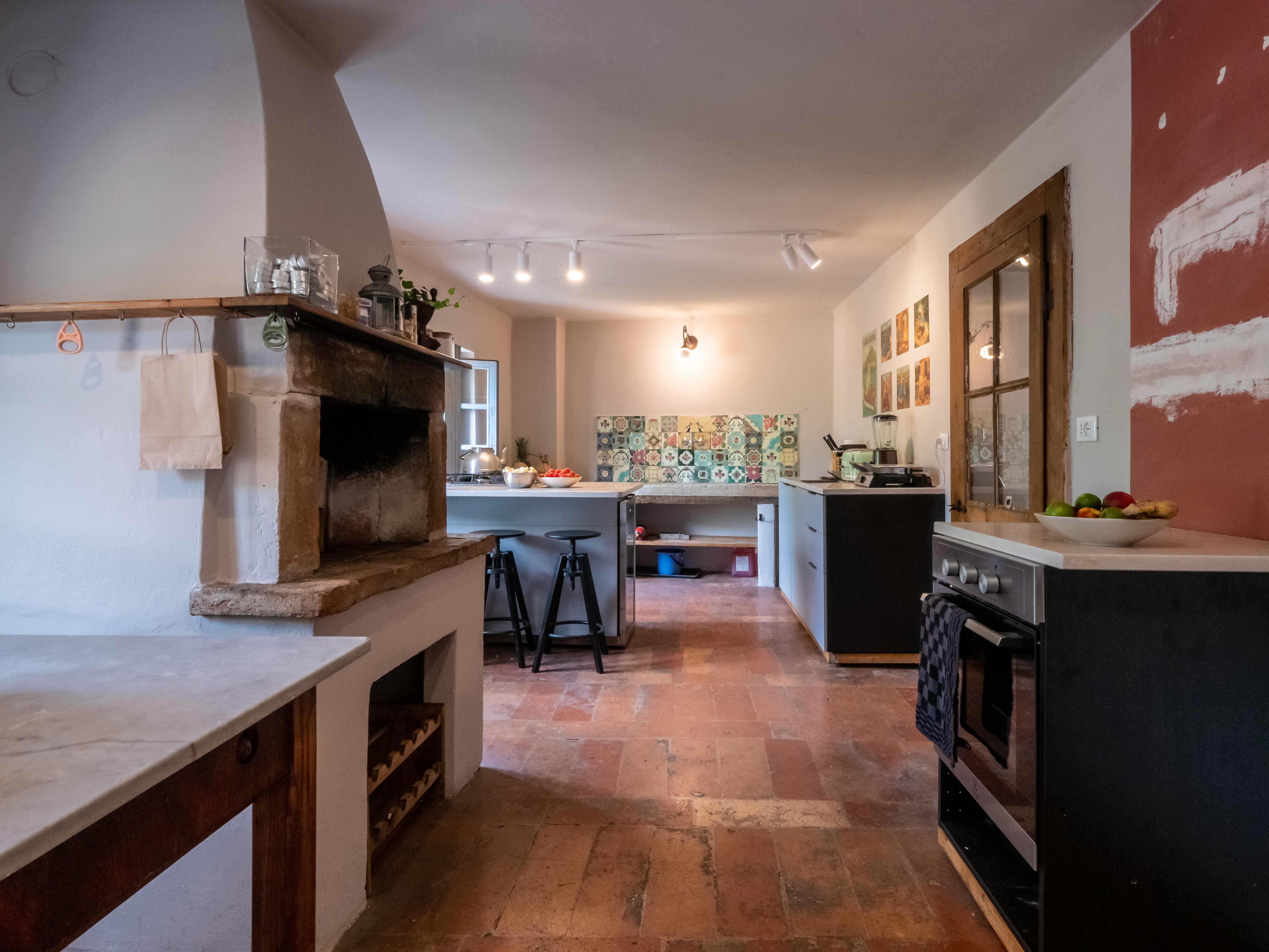 Historic 800-year-old kitchen with modern facilities and ancient stone fireplace