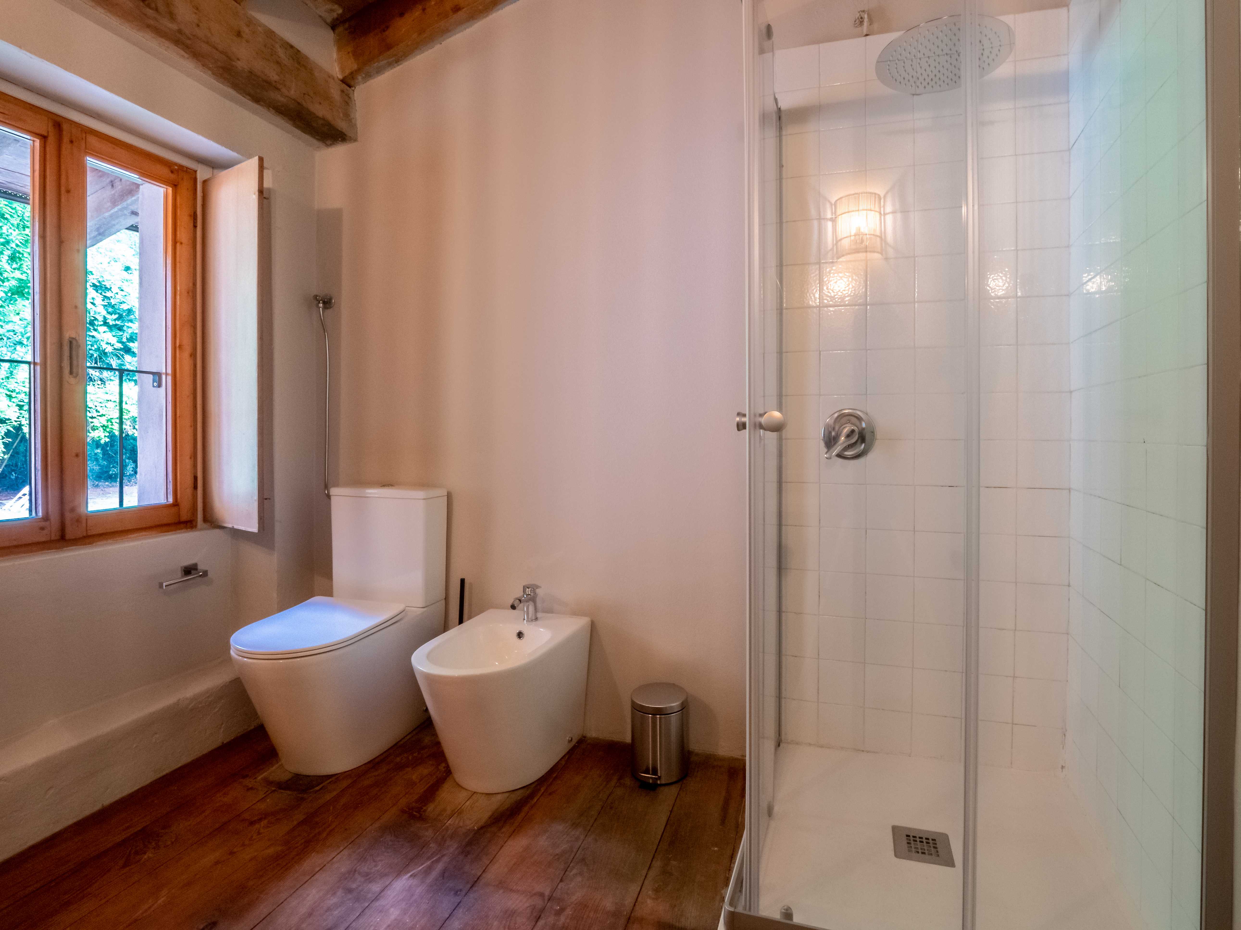 Complete bathroom with modern fixtures and exposed beams