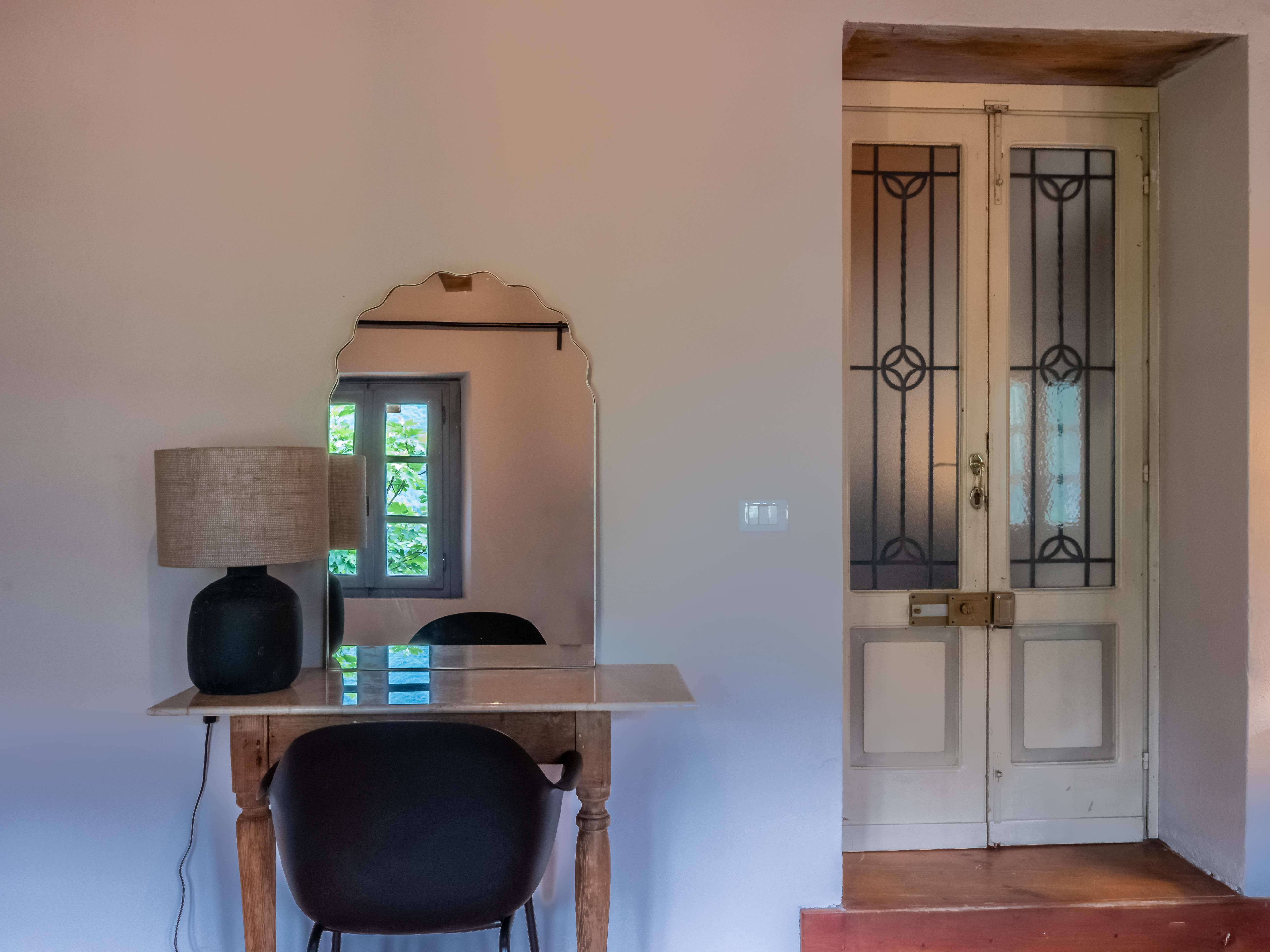 Elegant work area with vintage mirror and decorative doors