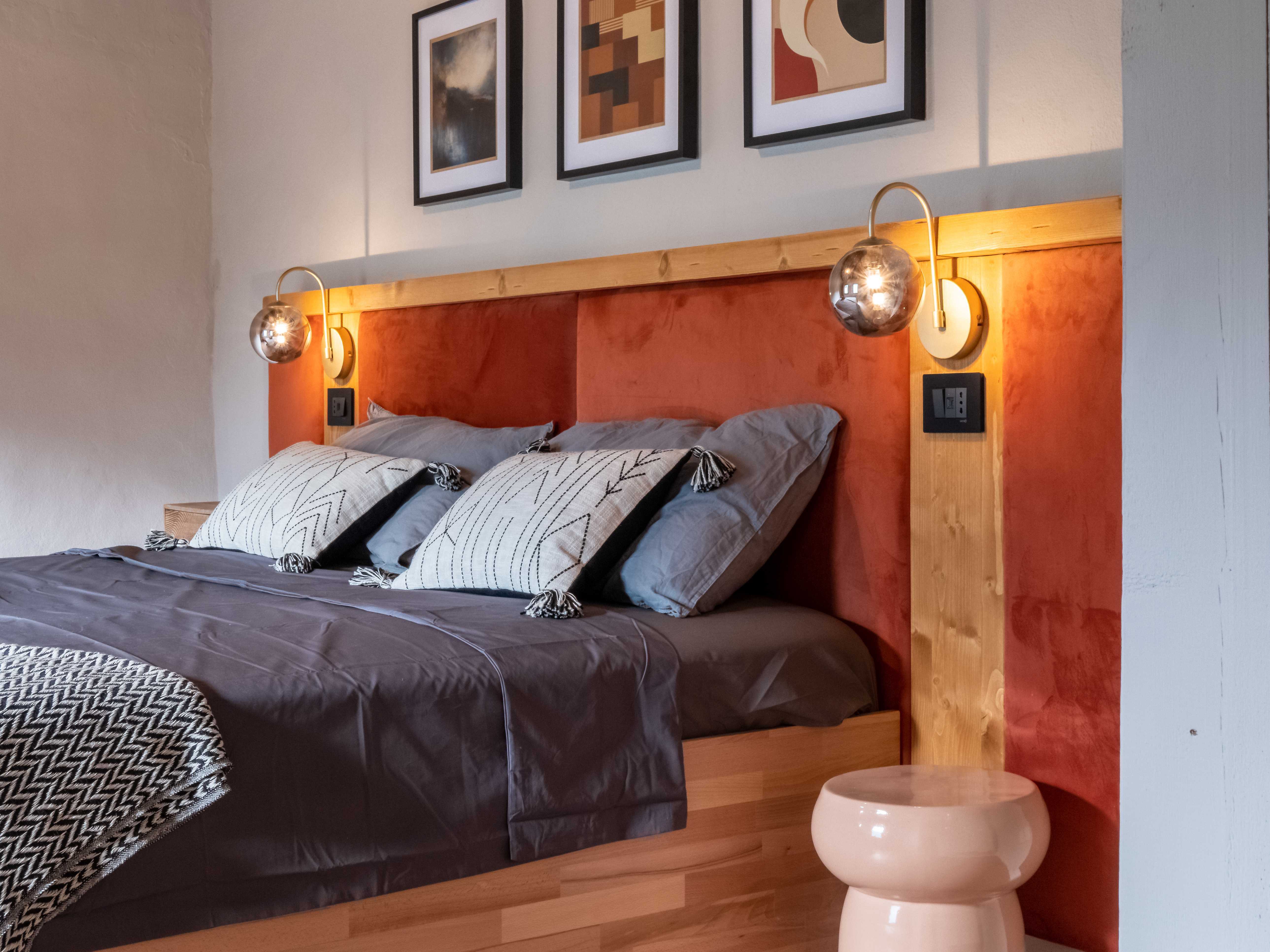 Mountain Suite bedroom with contemporary artwork and pendant lighting