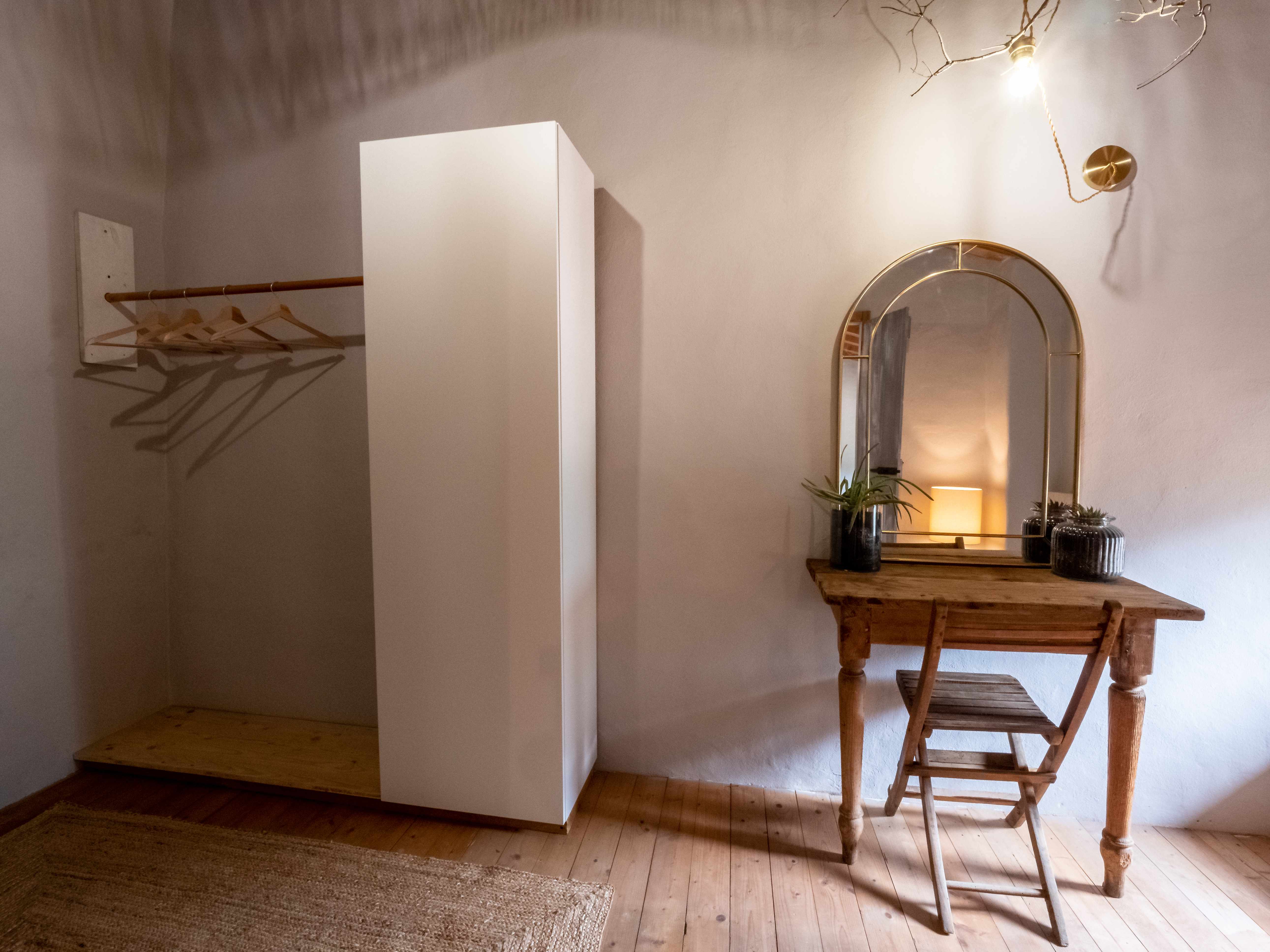 Separate wardrobe room with built-in storage and vanity desk