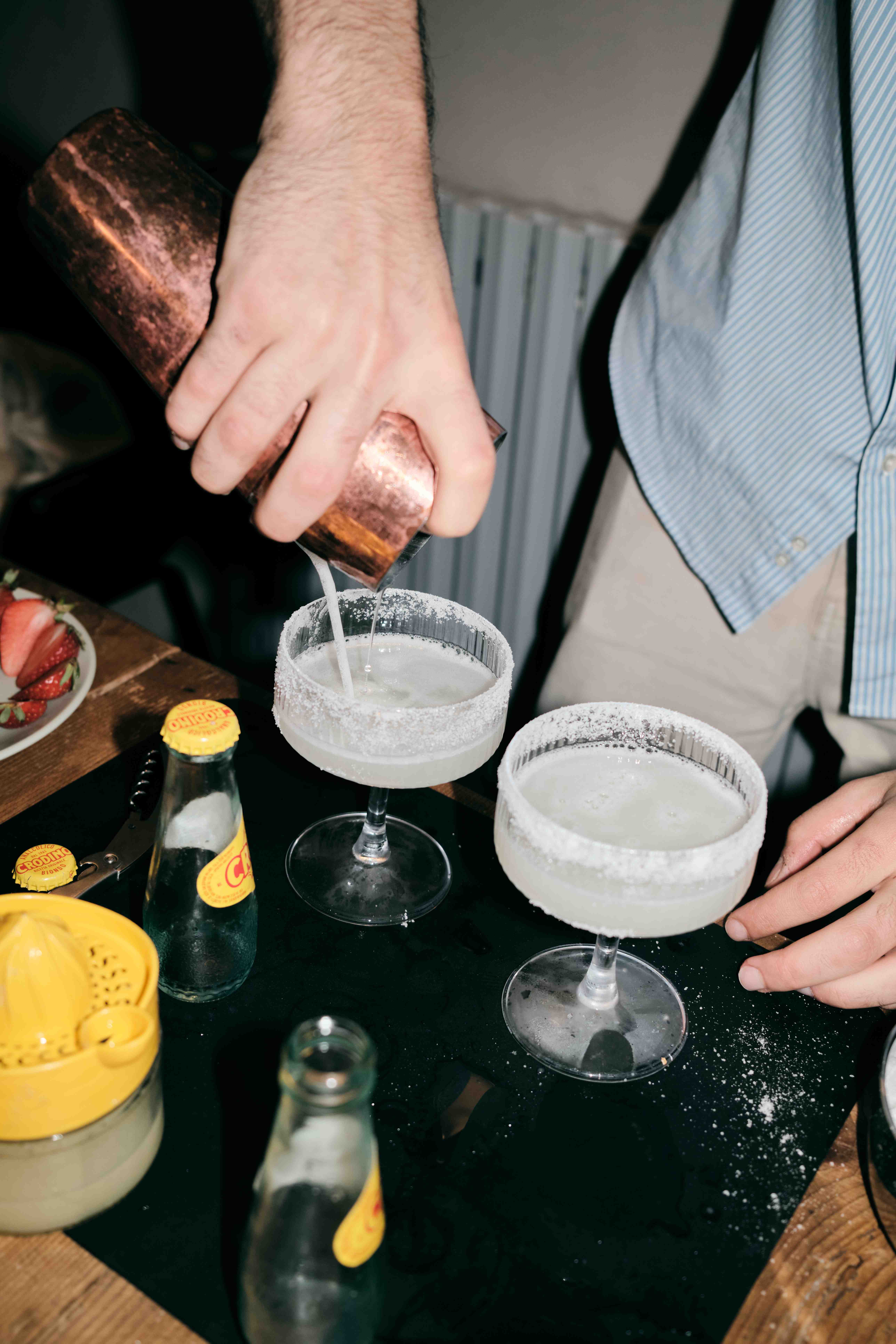 Cocktail poured into salt-rimmed coupe glasses